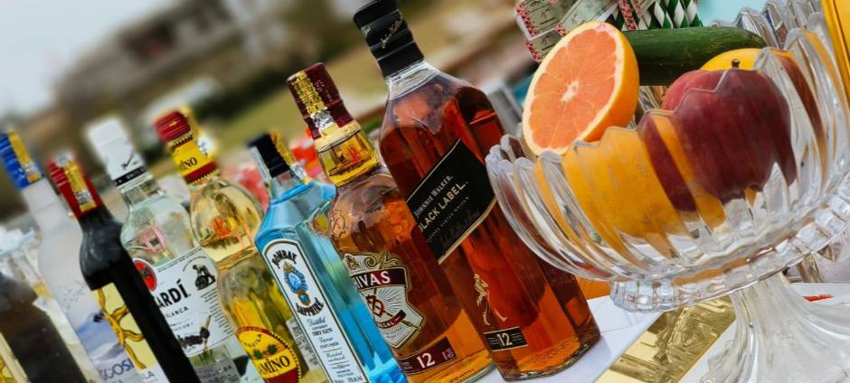 Bartender serving guests at a lively event with a beautifully decorated bar