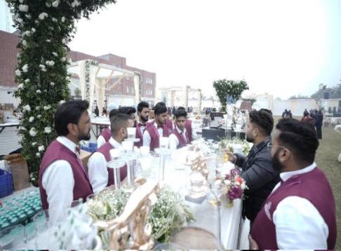 Outdoor wedding reception featuring a well-organized bar and bartending service
