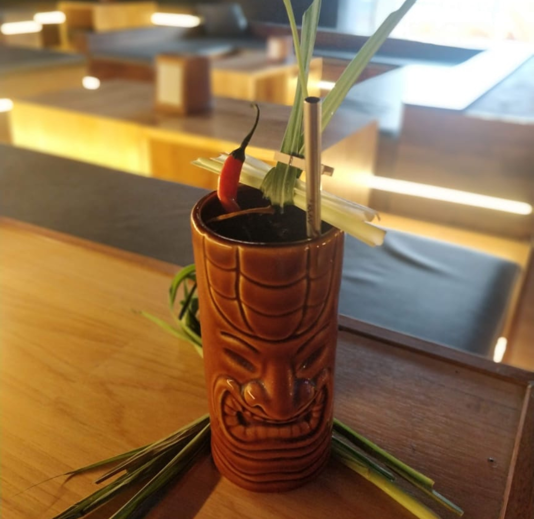 Transport yourself to paradise with a tropical cocktail masterpiece created by Mohit, featuring vibrant flavors and artistic presentation in a classic tiki glass.