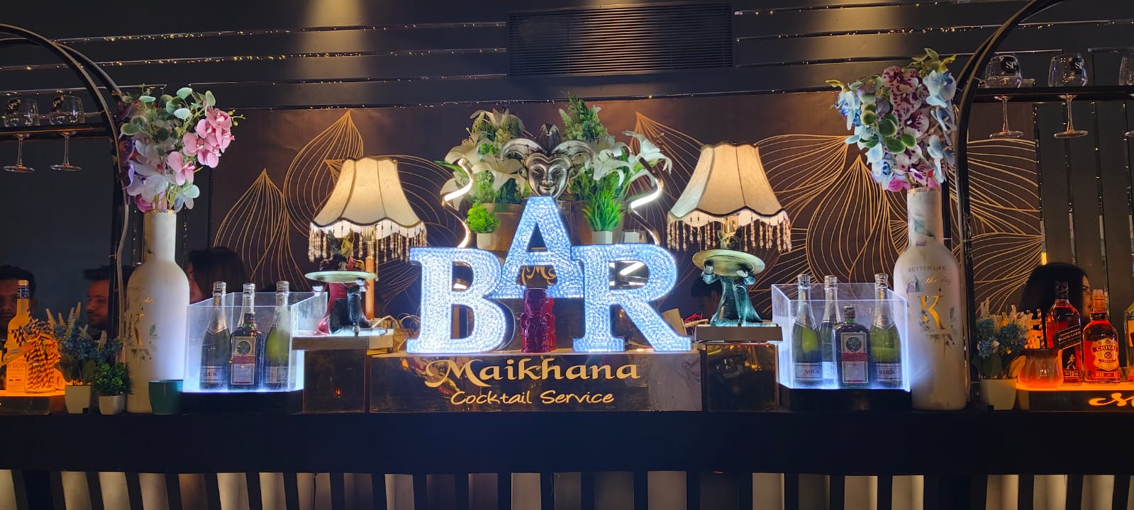 Elegant bar setup with a variety of drinks and glassware, perfect for any event.