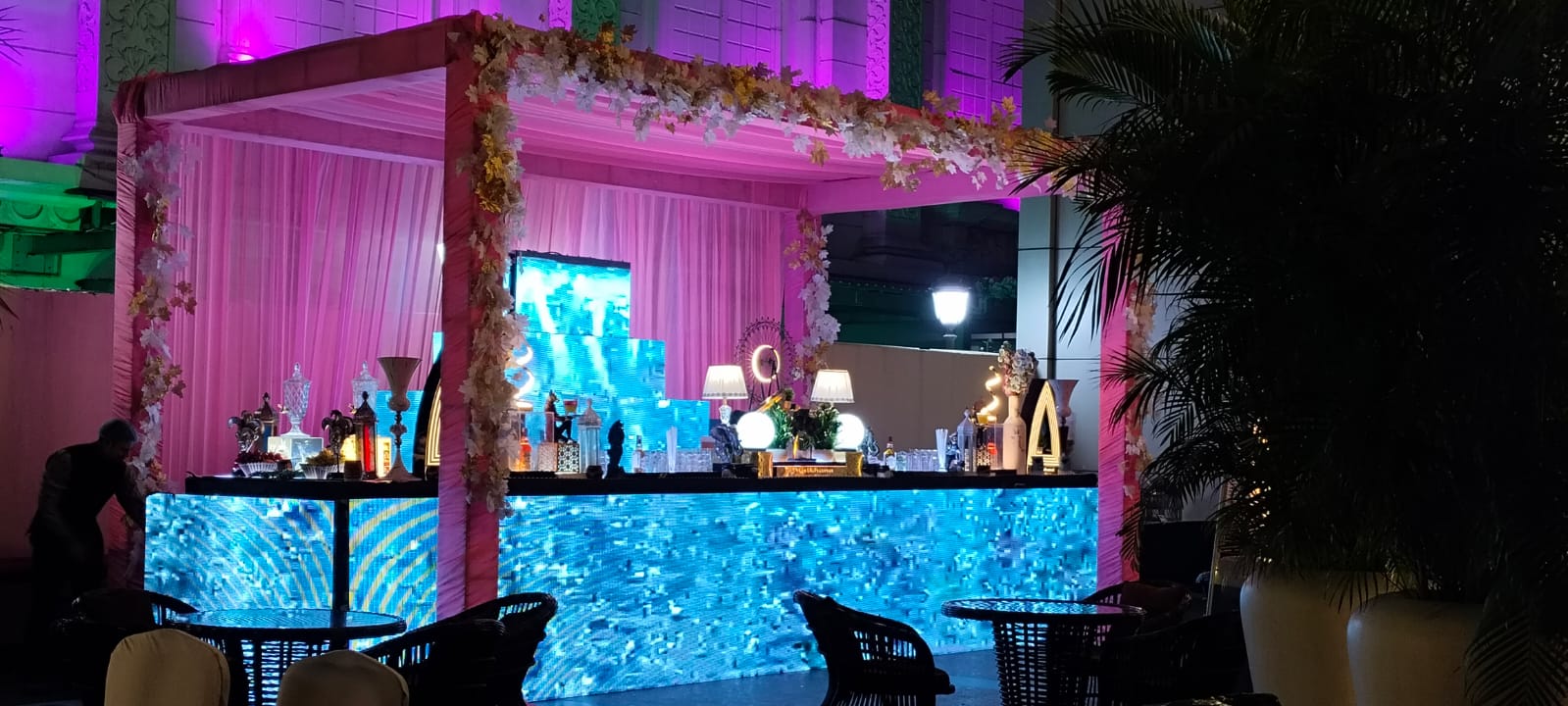 Professional bartender crafting a cocktail at a stylish bar during a wedding