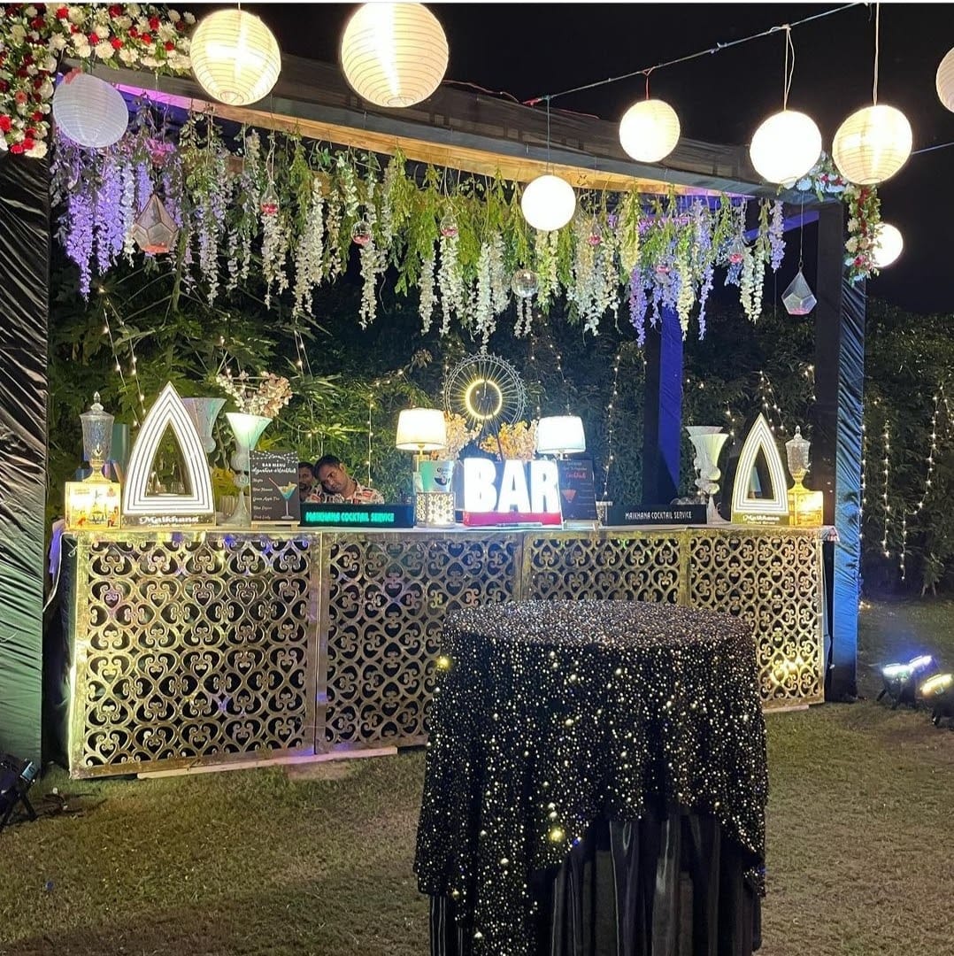 Outdoor wedding reception featuring a well-organized bar and bartending service
