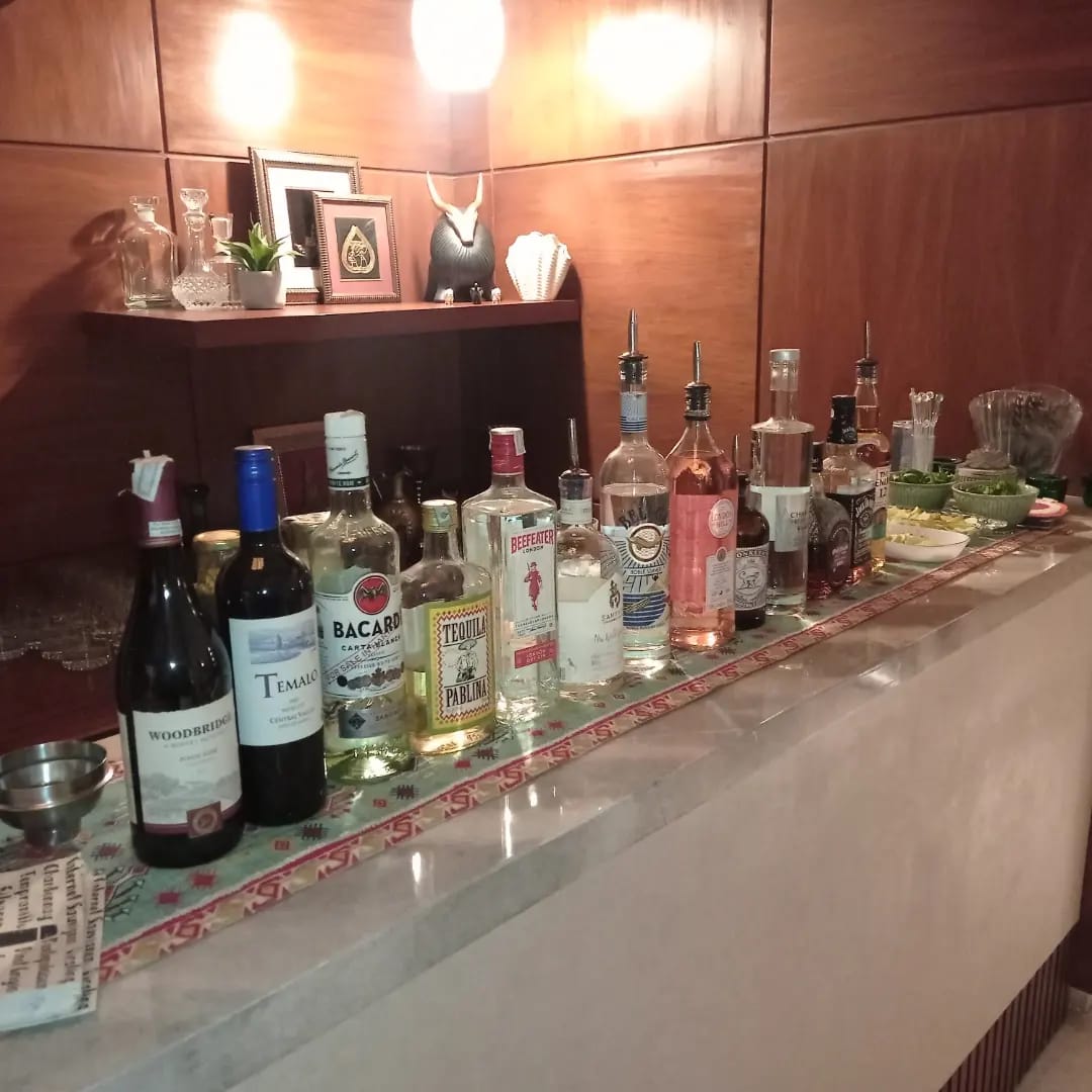 Bartender serving guests at a lively event with a beautifully decorated bar