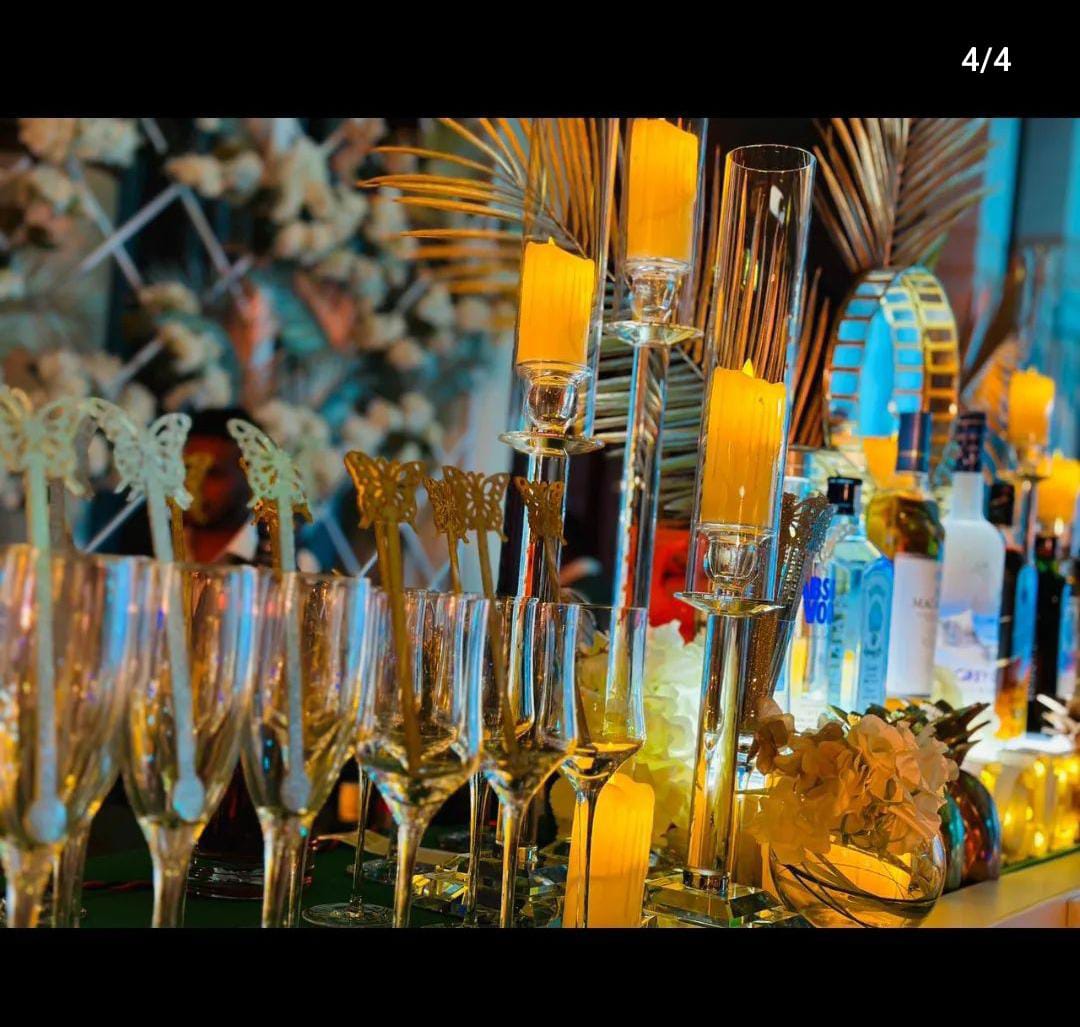 Outdoor wedding reception featuring a well-organized bar and bartending service